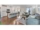 Open-concept living room and kitchen with hardwood floors and modern furnishings at 12425 Larue Ln, Huntersville, NC 28078