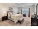 Serene main bedroom with plush carpeting, tray ceiling, and ample natural light at 12425 Larue Ln, Huntersville, NC 28078