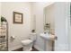 Powder room featuring a pedestal sink and decorative accents at 12425 Larue Ln, Huntersville, NC 28078