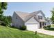 Two-story home with attached garage and a neatly kept lawn on a sunny day at 137 Mossy Pond Rd, Statesville, NC 28677