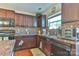 Classic kitchen with dark wood cabinets, mosaic backsplash, and modern appliances at 137 Mossy Pond Rd, Statesville, NC 28677