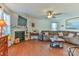 Cozy living room featuring a fireplace, large sectional sofa, and hardwood floors at 137 Mossy Pond Rd, Statesville, NC 28677