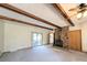 Spacious living room with exposed wood beams, brick fireplace, and a sliding glass door at 1376 Devinney Rd, York, SC 29745