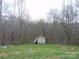 The spacious backyard is enclosed with a chainlink fence and features a shed with a leaning roof at 14440 W Highway 55 Hwy, Blacksburg, SC 29702