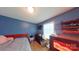Cozy bedroom with wood floors, a blue accent wall, and a window bringing in natural light at 14440 W Highway 55 Hwy, Blacksburg, SC 29702