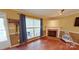 Bright living room featuring wood floors and a brick fireplace at 14440 W Highway 55 Hwy, Blacksburg, SC 29702