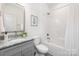 Bright bathroom with granite vanity, tub with shower, and tile floor at 1505 W May Ave, Gastonia, NC 28052