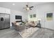 Spacious living area featuring a sofa, chairs, modern décor, and a view of the kitchen at 1505 W May Ave, Gastonia, NC 28052