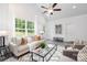 Bright living room featuring neutral tones, a large window, and stylish contemporary furniture at 1505 W May Ave, Gastonia, NC 28052