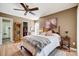 This bedroom features a ceiling fan, wood flooring, and a comfortable bed at 1608 Sharon W Rd # 56, Charlotte, NC 28210