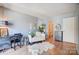 Bright living room featuring hardwood floors and neutral walls and access to the bathroom at 1608 Sharon W Rd # 56, Charlotte, NC 28210