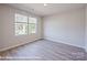 Well-lit bedroom features sleek gray flooring and a window offering natural light at 164 S Sycamore St, Mooresville, NC 28115