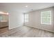 Bright, sunny bedroom with gray flooring and two windows overlooking a landscaped yard at 164 S Sycamore St, Mooresville, NC 28115