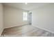 Well-lit bedroom with light wood floors, a window and white walls, creating a serene and inviting space at 164 S Sycamore St, Mooresville, NC 28115