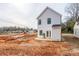 New construction home displays a bright white exterior, dark roof and unfinished backyard; a clean palette ready for your custom design at 164 S Sycamore St, Mooresville, NC 28115