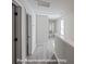 Upstairs hallway with modern gray flooring and natural light from the windows on the right at 164 S Sycamore St, Mooresville, NC 28115