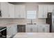 Modern kitchen with stainless steel appliances, white cabinets and countertops at 164 S Sycamore St, Mooresville, NC 28115