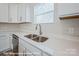 Kitchen with white cabinets, stainless steel appliances, and white countertops at 164 S Sycamore St, Mooresville, NC 28115