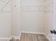 White walk-in closet with metal shelving and wood-look flooring, ready for custom organization at 164 S Sycamore St, Mooresville, NC 28115