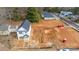 Aerial view of a two-story home with a dark roof surrounded by cleared land at 166 S Sycamore St, Mooresville, NC 28115