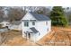 Exterior view of a two-story home with white siding, black roof, and an attached garage at 166 S Sycamore St, Mooresville, NC 28115