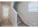Hallway featuring wood-look floors and a staircase with white railing at 166 S Sycamore St, Mooresville, NC 28115