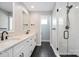 Modern bathroom features dual sinks, marble countertops, walk-in shower with glass door, and matte black hardware at 1906 Maius Dr, Conover, NC 28613