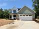 Charming two-story home with white and green siding, a two-car garage, and a well-manicured front yard at 1906 Maius Dr, Conover, NC 28613