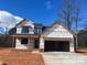 New construction two-story home with an attached two car garage on a sunny day at 1906 Maius Dr, Conover, NC 28613