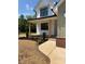 A charming home featuring a welcoming front porch with stylish wooden pillars and manicured garden beds at 1906 Maius Dr, Conover, NC 28613