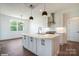 Modern kitchen boasts a large center island with white countertops and contemporary pendant lighting fixtures at 1906 Maius Dr, Conover, NC 28613