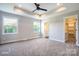 Spacious main bedroom offers tray ceiling, ceiling fan, and abundant natural light from dual windows, with ensuite access at 1906 Maius Dr, Conover, NC 28613