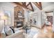 Living room with fireplace, wood beams, hardwood floors, and lots of natural light at 2028 Fitzhugh Ln, Weddington, NC 28104