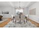 Formal dining room with large windows, chandelier, and neutral decor, adjacent to the living room at 226 Fairview Ln, Davidson, NC 28036