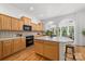 Well-lit kitchen featuring light wood cabinets, a large island, and modern appliances at 226 Fairview Ln, Davidson, NC 28036