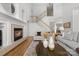 Cozy living room with a fireplace, hardwood floors, and elegant decor leading to the staircase at 226 Fairview Ln, Davidson, NC 28036