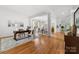 Bright living area featuring hardwood floors, decorative columns, and an adjacent dining area at 226 Fairview Ln, Davidson, NC 28036