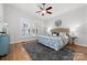 Serene main bedroom featuring hardwood floors, a ceiling fan, and large windows for natural light at 226 Fairview Ln, Davidson, NC 28036