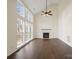 Bright living room featuring a fireplace, many windows, vaulted ceilings, and a ceiling fan at 227 Tyndale Ct, Waxhaw, NC 28173