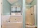 Bathroom showcasing a soaking tub with shower, and a window for natural light at 2339 Perry Rd, Denver, NC 28037