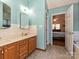 Bathroom featuring a double vanity with wood cabinets, and access to the main bedroom at 2339 Perry Rd, Denver, NC 28037