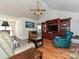 Inviting living room boasts hardwood floors, vaulted ceiling, and wooden built-in shelving at 2339 Perry Rd, Denver, NC 28037