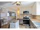 Modern kitchen featuring stainless steel appliances, granite countertop, and an open concept living room at 2417 Fowler Secrest Rd, Monroe, NC 28110