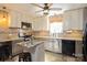 Bright kitchen featuring an island with granite countertop, tile backsplash, and stainless steel appliances at 2417 Fowler Secrest Rd, Monroe, NC 28110