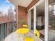 Cozy balcony with a yellow bistro set and an open sliding glass door at 300 W 5Th W St # 407, Charlotte, NC 28202