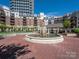 Beautiful courtyard featuring a brick-paved ground, fountain, gazebo and surrounding condominium buildings at 300 W 5Th W St # 407, Charlotte, NC 28202