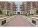 Walkway leading to an apartment complex with an arched entryway and manicured landscaping at 300 W 5Th W St # 407, Charlotte, NC 28202