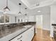 Spacious kitchen with granite countertops, stainless steel appliances, and hardwood floors at 300 W 5Th W St # 407, Charlotte, NC 28202