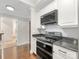 Kitchen featuring granite countertops, stainless steel appliances, and white cabinets at 300 W 5Th W St # 407, Charlotte, NC 28202