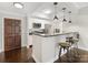 Stylish kitchen features stainless steel appliances, granite countertops, breakfast bar and hardwood floors at 300 W 5Th W St # 407, Charlotte, NC 28202